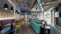 Located at 1601 Central Ave in Saint Petersburg, Florida, this single-floor communal space showcases a striking blend of industrial architecture and vivid, contemporary design. Polished concrete floors run throughout, reflecting the abundant natural light that enters through large windows framing views of surrounding palm trees and the urban streetscape.

The main lounge area features plush tufted sofas in a bold turquoise hue, anchored by patterned area rugs and complemented by dark accent tables. Exposed concrete ceilings soar overhead, with visible ductwork and conduit adding to the industrial aesthetic, while clusters of matte black pendant lights provide warm, layered illumination. A graphic geometric mural with a sea turtle motif serves as a prominent focal point, reinforcing a distinctly Floridian identity.

A dining and café-style seating zone lines one wall, furnished with upholstered banquette seating, black pedestal tables, and vibrant yellow chairs beneath a textured, backlit wall panel. A wall-mounted television and lounge furniture create a relaxed media area nearby.

The entrance corridor is distinguished by an elaborate black-and-white illustrated mural wrapping the entryway door. A separate lobby area features a warm wood-paneled tray ceiling, globe light fixtures, polished floors, and sleek elevator banks, conveying a polished, welcoming arrival experience.