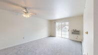 This 2-bedroom, 1-bathroom unit in Glendale, Wisconsin offers a practical and comfortable single-floor layout with a clean, neutral aesthetic throughout. The living room is a standout space, featuring plush carpeting, a ceiling fan with light fixture, and a sliding glass door that fills the room with natural light and opens directly onto a private patio with outdoor views. The kitchen is positioned adjacent to the living area and features wood-toned cabinetry, laminate countertops, a stainless steel sink, and durable hardwood-style flooring — providing both functionality and warmth. The two bedrooms are carpeted and well-lit, each with windows that bring in natural light; the primary bedroom is generously sized and includes baseboard heating. The full bathroom is finished with hardwood-style flooring, a wall-mounted sink, a mirrored medicine cabinet, and a full tub-shower combination. Storage is plentiful, with three closets throughout the unit — including a spacious walk-in closet equipped with wire shelving. A welcoming entrance and connecting hallway round out this thoughtfully designed unit, making it an efficient and comfortable living space.