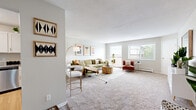 Located at 301 Shelard Pkwy in St. Louis Park, Minnesota, this two-bedroom, two-bathroom residence offers a well-organized single-floor layout. The spacious living room is a welcoming centerpiece, featuring plush carpet, a textured ceiling, and large windows that invite generous natural light and views of the surrounding greenery. The open layout connects seamlessly to a dining area, making it well-suited for everyday living and entertaining.

The kitchen is thoughtfully appointed with white shaker-style cabinetry, granite-look countertops, wood-look flooring, and a full suite of stainless steel appliances including a gas range, microwave, and dishwasher. It offers ample storage and counter space for comfortable meal preparation.

The primary bedroom is generously sized, featuring soft carpet and a window with outdoor views. The second bedroom is comfortably proportioned, also carpeted, and filled with natural light. Both bathrooms include tub-shower combinations, granite-look vanity tops, and wood-look flooring, providing a clean and functional design.

A hallway connects the main living areas to the private quarters, with a dedicated closet offering practical storage. The neutral color palette throughout creates a calm, cohesive atmosphere across the entire residence.