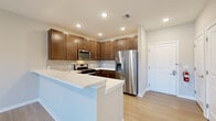 Located at 264 Passaic Ave in Fairfield, NJ, this well-appointed 2-bedroom, 2-bathroom residence offers a thoughtfully designed single-floor layout that balances comfort and modern style. Light wood-tone flooring flows through the open-concept living and dining areas, complemented by recessed lighting and neutral-toned walls that create a bright, welcoming ambiance. The kitchen is a standout feature, showcasing rich walnut-toned cabinetry, white quartz countertops, a subway tile backsplash, and a full suite of stainless steel appliances including a gas range, microwave, dishwasher, and French door refrigerator. A peninsula counter provides additional workspace and casual seating. The spacious primary bedroom offers generous proportions with plush carpeting and easy access to its dedicated bathroom. The second bedroom also features carpeted flooring and a large window with ample natural light. Both bathrooms are finished with clean white tile; one features a glass-enclosed walk-in shower, while the other includes a soaking tub with a rain showerhead. A dedicated closet provides convenient storage. The overall design palette is clean, contemporary, and move-in ready.