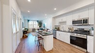 Located at 1900 E Inland Empire Blvd in Ontario, CA, this thoughtfully designed one-bedroom, one-bathroom residence offers a functional and modern living experience across a single floor. The open-concept layout seamlessly connects the kitchen, dining, and living areas, creating a bright and cohesive space ideal for both everyday living and entertaining.

The kitchen is a standout feature, equipped with stainless steel appliances, crisp white cabinetry, subway tile backsplash, and dark countertops. A central island with bar seating provides additional prep space and casual dining options, while recessed lighting adds a clean, polished look.

The living room benefits from large windows dressed with stylish curtains that allow generous natural light to fill the room, with views of the surrounding community. Wood-style flooring runs throughout the main living areas, adding warmth and continuity.

The bedroom is a comfortable retreat, featuring wood-style flooring, a window for natural light, and a dedicated closet for storage. The bathroom is finished with tile flooring, a combined tub and shower, dark countertop vanity with white cabinetry, and built-in shelving for added convenience. A welcoming entrance completes this well-rounded and efficiently designed residence.
