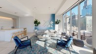 Located in Chicago's vibrant Fulton Market/West Loop neighborhood, this stylish amenity lounge offers an exceptional urban retreat with sweeping panoramic views of the Chicago skyline. The space is defined by expansive floor-to-ceiling glass walls that flood the interior with abundant natural light throughout the day, creating a seamless visual connection between the indoors and the surrounding cityscape.

The main lounge area features a sophisticated seating arrangement centered around a sculptural metallic coffee table atop a blue and teal geometric area rug. A curved, textured sofa is complemented by sleek navy blue armchairs and acrylic ghost chairs, lending the space a contemporary yet inviting character. A dramatic blue ombre feature wall adorned with a three-dimensional sculptural art installation serves as a striking focal point, flanked by tall potted fiddle-leaf fig trees that introduce a lush, natural element.

Large-format white porcelain tile flooring runs throughout, adding to the clean, modern aesthetic. A wall-mounted television is suspended from the ceiling near the glass facade, offering views both on-screen and beyond. A wet bar area with a textured 3D wave-patterned tile backsplash, white countertop, and an undermount brass sink provides a refined service station. Floor-to-ceiling sliding glass doors open directly onto a spacious furnished outdoor terrace, extending the entertaining space into the open air.