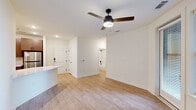 Located at 103 East 2nd Street in Richmond, VA, this well-designed 2-bedroom, 2-bathroom residence offers a clean, modern aesthetic across a single floor. The open living area welcomes you with light wood-style flooring, crisp white walls, and a stylish ceiling fan with integrated lighting. Natural light filters in through blinds-fitted windows, enhancing the bright, airy atmosphere. The kitchen features dark espresso cabinetry, white countertops, stainless steel appliances including a refrigerator, microwave, and range, and a matte black undermount sink — a cohesive and functional design. Both bedrooms are carpeted for comfort, each equipped with a ceiling fan and windows that bring in natural light. The spacious primary bedroom includes access to a walk-in closet outfitted with wire shelving for organized storage. The bathrooms are finished with wood-toned vanities, white countertops, large mirrors, and matte black fixtures, with a tub-shower combination. A dedicated laundry area houses a front-loading washer and dryer with additional overhead shelving. Two closets provide ample storage throughout the residence. The overall design is modern and cohesive, with consistent finishes creating a polished, move-in-ready feel.