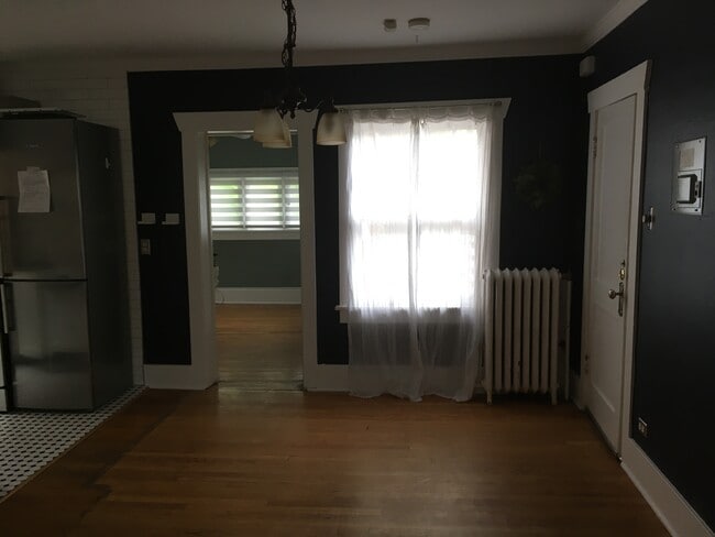 Dining area looking towards bedroom and window onto deck. - 945 Washington St Apartments