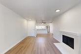 Located in Everett, WA, this 2-bedroom, 2-bathroom residence offers a well-designed single-floor layout with clean, modern finishes throughout. The open-concept living and dining area is a welcoming focal point of the home, featuring light wood-style flooring, crisp white walls, a ceiling fan, and a classic white-mantled fireplace. Sliding glass doors lead to a private balcony, filling the space with natural light and outdoor views. The kitchen is efficiently laid out with white cabinetry, light countertops, a stainless steel refrigerator, electric range, dishwasher, and a window above the sink that brings in additional natural light. Both bedrooms are carpeted for comfort, each featuring windows that allow natural light and a baseboard heating system. The primary bedroom offers a generous footprint with ample room for furnishings. The two bathrooms are clean and functional, with white vanities, updated fixtures, and one featuring a full tiled tub-shower combination with a window. A hallway connects the private areas of the home seamlessly. The unit's fresh, neutral palette and updated details create a bright, move-in ready environment suited for comfortable everyday living.