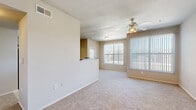 Located in Houston, TX, this single-story 2-bedroom, 2-bathroom residence offers a practical and comfortable layout designed for everyday living. The open living room is bright and welcoming, featuring plush carpeting, a ceiling fan with light fixture, and large windows with vertical blinds that flood the space with natural light. A pass-through counter connects the living area to the galley-style kitchen, which is equipped with warm wood cabinetry, granite-style countertops, a double-basin sink, and white appliances including a range, microwave, and refrigerator. Tile flooring runs throughout the kitchen, which also includes a pantry for additional storage. Both bedrooms are generously sized with soft carpeting, ceiling fans, and large windows. The primary bedroom offers direct access to its own bathroom and features an expansive walk-in closet with wire shelving. The second bathroom includes tile flooring, a vanity with wood cabinetry, and accessibility grab bars. A dedicated laundry area and multiple closets add functional storage throughout. The unit also includes a private patio, providing outdoor space. With five closets total and a well-organized floor plan, this residence delivers efficient, comfortable living in a single-level setting.