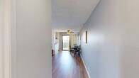 Located on the iconic Hollywood Boulevard in Los Angeles, this one-bedroom, one-bathroom unit offers a well-organized, single-floor layout designed for comfortable city living. Warm hardwood-style flooring runs throughout, tying each room together cohesively.

The living room is a bright, welcoming space featuring a textured ceiling, a wall-mounted air conditioning unit, and a window that allows natural light to fill the room. The open sightline from the entry hallway leads naturally into the dining and living area, which benefits from a sliding glass door with outdoor access and a ceiling fan overhead.

The galley-style kitchen is efficiently designed with white cabinetry, granite-look countertops, a stainless steel sink, and white appliances including a refrigerator, oven, and microwave — offering all the essentials in a compact, functional footprint.

The bedroom is a comfortable, light-filled retreat with a large window overlooking the surrounding neighborhood, a wall-mounted air conditioning unit, and a dedicated closet with built-in rod storage. A hallway connects the bedroom to the full bathroom, which features a shower/tub combo with a window providing natural light.

Completing the layout is a hallway and additional storage closet, making smart use of every square foot in this conveniently located Hollywood residence.