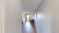 Located on the iconic Hollywood Boulevard in Los Angeles, this one-bedroom, one-bathroom unit offers a well-organized, single-floor layout designed for comfortable city living. Warm hardwood-style flooring runs throughout, tying each room together cohesively.

The living room is a bright, welcoming space featuring a textured ceiling, a wall-mounted air conditioning unit, and a window that allows natural light to fill the room. The open sightline from the entry hallway leads naturally into the dining and living area, which benefits from a sliding glass door with outdoor access and a ceiling fan overhead.

The galley-style kitchen is efficiently designed with white cabinetry, granite-look countertops, a stainless steel sink, and white appliances including a refrigerator, oven, and microwave — offering all the essentials in a compact, functional footprint.

The bedroom is a comfortable, light-filled retreat with a large window overlooking the surrounding neighborhood, a wall-mounted air conditioning unit, and a dedicated closet with built-in rod storage. A hallway connects the bedroom to the full bathroom, which features a shower/tub combo with a window providing natural light.

Completing the layout is a hallway and additional storage closet, making smart use of every square foot in this conveniently located Hollywood residence.