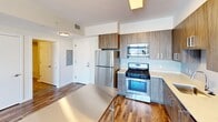 This contemporary 780 square foot apartment in Stamford, CT, showcases a thoughtful blend of style and functionality. The open-concept layout seamlessly integrates the kitchen and living area, creating a spacious feel. The kitchen boasts sleek, wood-grain cabinetry, stainless steel appliances, and a convenient island, perfect for casual dining or food preparation.

Large windows throughout flood the space with natural light and offer stunning city views, enhancing the urban living experience. The primary bedroom, an impressive 330 square feet, provides ample space for relaxation. Hardwood flooring throughout adds warmth and elegance to the entire apartment.

The bathroom features modern fixtures, including a floating vanity and a washer-dryer unit for added convenience. The second bedroom, while smaller, still offers comfortable living space. High ceilings and recessed lighting contribute to the overall sense of openness and modernity.

This well-designed apartment efficiently utilizes its 780 square feet, offering a perfect balance of comfort and style for urban dwellers seeking a contemporary living space in the heart of Stamford.