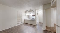 Located at 4015 Callaghan Rd in San Antonio, Texas, this single-story, 3-bedroom, 2-bathroom home offers a practical and well-organized layout. The open living area features wood-look flooring and connects seamlessly to the kitchen via a breakfast bar peninsula, illuminated by pendant lighting overhead. The kitchen is appointed with dark wood cabinetry, light stone-look countertops, a built-in dishwasher, electric range, refrigerator, and a window that brings in natural light. A pantry provides additional storage.

The three bedrooms are carpeted for comfort and each includes a ceiling fan with light fixture. The primary bedroom features an en-suite bathroom with wood-look flooring, a dark wood vanity, and a tub/shower combination adorned with marble-style tile surround. Multiple closets, including reach-in and shelved options, are distributed throughout the bedrooms and bathrooms, offering generous storage. A second full bathroom serves the remaining bedrooms.

Additional spaces include a hallway, a utility room, and a total of four closets across the home. Textured ceilings are present throughout. The efficient floor plan makes thoughtful use of every area, providing a functional and comfortable living environment.
