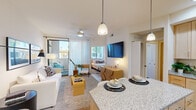 Located in Scottsdale, AZ, this thoughtfully designed 2-bedroom, 1-bathroom residence makes excellent use of its compact footprint across a single level. The open-concept living and kitchen area serves as the heart of the home, where light wood-look flooring, neutral walls, and a ceiling fan create a fresh, airy atmosphere. The kitchen is well-appointed with light maple cabinetry, granite countertops, stainless steel appliances including a range, microwave, and refrigerator, recessed lighting, and a peninsula island ideal for casual dining. The living room flows seamlessly from the kitchen, offering a welcoming space bathed in natural light, with a sliding barn-style door opening to a private balcony. The primary bedroom features a ceiling fan, a large window overlooking greenery, and generous space for furnishings. The second bedroom is equally comfortable, with its own window and ceiling fan. A hallway with built-in closet storage connects the bedrooms to the full bathroom, which includes a granite vanity, wood-tone cabinetry, and a tub-shower combination. Clean lines and warm, consistent finishes throughout give this Scottsdale residence a cohesive and inviting character.