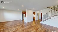 Located at The Clipper in Quincy, Massachusetts, this two-floor residence offers a well-appointed layout with a combination of hardwood-style flooring and plush carpeting throughout. The open floor plan is complemented by recessed lighting and crisp white walls, creating a bright and clean aesthetic across both levels.

The kitchen is equipped with warm-toned wood cabinetry, white subway tile backsplash, stainless steel appliances including a refrigerator, range with microwave, and dishwasher, along with light countertops and hardwood-style flooring that extends into the adjoining living areas.

Bedrooms feature carpeted floors, generous closet space including a walk-in closet with wire shelving, and large windows that frame notable waterfront views. A sliding glass door in one bedroom opens to a private balcony overlooking the water, offering an exceptional outdoor vantage point.

Two bathrooms are finished with marble-look tile flooring and wall surrounds. One bathroom includes a full tub-shower combination and a white vanity with a stone-top countertop. The second bathroom is more compact and conveniently houses a stacked in-unit washer and dryer. Wall-unit HVAC systems are present throughout for individualized climate control.