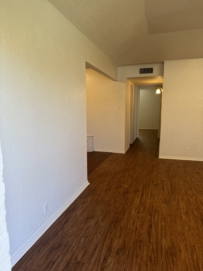 living room leading to bed and bathrooms - 6859 S Creek Dr