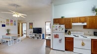 Located in Iowa City, Iowa, this single-floor unit offers three bedrooms, two full bathrooms, and a functional, efficiently arranged layout. The open-concept living and kitchen area forms the heart of the home, with the living room featuring carpet flooring, a ceiling fan with light fixture, and a window that brings in natural light. The kitchen is positioned adjacent to the living space, outfitted with warm oak cabinetry, white appliances including a range and refrigerator, a stainless steel dishwasher, a double sink, and tile flooring — providing all essential amenities in a compact, well-organized space.

The three bedrooms are carpeted and each include windows for natural light. The primary bedroom offers a cozy, functional layout, while the additional bedrooms provide versatile spaces suitable for sleeping, studying, or working, with built-in closets featuring classic wood-panel doors. Two hallways connect the rooms, supporting smooth circulation throughout the unit.

Both bathrooms feature tub-shower combinations with curtains and tiled flooring, offering straightforward, practical design. Textured ceilings are consistent throughout. Two hallways connect the rooms efficiently. The overall layout is well-suited for shared living, making it an ideal option for students or young professionals in the Iowa City area.
