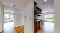 Located at 305 Euclid Ave in Oakland's vibrant 94610 neighborhood, this single-floor residence offers a thoughtfully designed layout with a cohesive aesthetic throughout. Rich hardwood flooring runs continuously across the space, adding warmth and a sense of visual continuity from room to room.

The kitchen is a standout feature, offering an abundance of dark wood cabinetry — including glass-front upper cabinets with diamond lattice detailing — complemented by granite countertops and stainless steel appliances. The galley-style configuration maximizes functionality while maintaining an open sightline into the adjoining living area.

The living room is generously proportioned, featuring recessed lighting, a classic brick fireplace, and a sliding glass door that opens to an outdoor patio, allowing natural light to fill the space and providing a seamless indoor-outdoor connection.

The bedroom includes dual closets with wood-paneled sliding doors, offering ample storage within a clean, open layout. The bathroom features a full tub-shower combination, marble-style tile flooring, and built-in overhead cabinetry for additional storage.

Overall, the space presents a practical and comfortable layout with classic design elements, well-maintained finishes, and a warm, inviting atmosphere throughout.