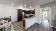 Located at 4826 Van Buren Blvd in Riverside, California, this single-story residence offers a well-designed, functional layout with modern finishes throughout. The kitchen is a standout feature, equipped with rich dark-wood cabinetry, granite countertops, a breakfast bar peninsula, stainless steel appliances including a gas range, microwave, refrigerator, and dishwasher, all set atop easy-care wood-style flooring. The living area is bright and welcoming, with warm-toned walls, wood-style flooring, and sliding glass doors that open directly to a private outdoor patio — ideal for enjoying the Southern California climate. The two bedrooms are comfortably sized, each featuring plush carpeting, natural light from large windows with blinds, and ample wall space. The two bathrooms are finished with granite-topped dark wood vanities, wood-style flooring, and full tub-shower combinations with clean white tile surrounds. Throughout the residence, a consistent design language of neutral tones, modern fixtures, and practical finishes creates a cohesive and comfortable living environment. The combination of indoor and outdoor living spaces makes this a well-rounded home in the heart of Riverside.