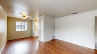 Located at 7100 Shoreline Dr in Stockton, California, this two-bedroom, one-bathroom residence offers a practical and well-organized single-floor layout. The living room is a welcoming space featuring warm hardwood flooring, crown molding, a ceiling fan, and a fireplace that serves as a focal point. Multiple windows allow natural light to flow throughout, creating a bright and airy atmosphere. The kitchen is efficiently designed with white cabinetry, light stone-toned countertops, a stainless steel sink, and white appliances including a range and refrigerator, complemented by a window for added natural light. Both bedrooms are carpeted and feature mirrored sliding closet doors that enhance the sense of space, along with crown molding and windows providing outdoor views. The bathroom includes a vanity with marble-style countertops, white cabinetry, a tub-shower combination, and hardwood flooring that ties into the rest of the home. Throughout the residence, consistent finishes such as crown molding, neutral wall tones, and hardwood flooring in the main living areas contribute to a cohesive and functional living environment.