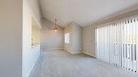 Located at 16425 S Harbor Blvd in Fountain Valley, CA, this 2-bedroom, 2-bathroom residence offers a well-designed single-floor layout with comfortable living spaces throughout. The living room is bright and airy, highlighted by vaulted ceilings, a ceiling fan, plush carpeting, and a full-width sliding glass door fitted with vertical blinds that opens to an outdoor balcony, filling the space with natural light. The kitchen features an open pass-through design with granite-look countertops, white cabinetry, stainless steel appliances including a refrigerator and microwave, and a skylight-style ceiling fixture that enhances the sense of openness. Both bedrooms are carpeted and generously proportioned, each equipped with mirrored sliding closet doors that add depth and reflect light. The primary bedroom offers a well-sized closet with built-in shelving. Both bathrooms are finished with wood-look tile flooring, white cabinetry with granite countertops, and a tub-shower combination. Neutral tones and clean finishes throughout give the home a cohesive, move-in ready aesthetic. A connecting hallway ties the layout together efficiently, making this a practical and comfortable Fountain Valley residence.