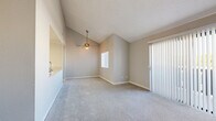 Located at 16425 S Harbor Blvd in Fountain Valley, CA, this 2-bedroom, 2-bathroom residence offers a well-designed single-floor layout with comfortable living spaces throughout. The living room is bright and airy, highlighted by vaulted ceilings, a ceiling fan, plush carpeting, and a full-width sliding glass door fitted with vertical blinds that opens to an outdoor balcony, filling the space with natural light. The kitchen features an open pass-through design with granite-look countertops, white cabinetry, stainless steel appliances including a refrigerator and microwave, and a skylight-style ceiling fixture that enhances the sense of openness. Both bedrooms are carpeted and generously proportioned, each equipped with mirrored sliding closet doors that add depth and reflect light. The primary bedroom offers a well-sized closet with built-in shelving. Both bathrooms are finished with wood-look tile flooring, white cabinetry with granite countertops, and a tub-shower combination. Neutral tones and clean finishes throughout give the home a cohesive, move-in ready aesthetic. A connecting hallway ties the layout together efficiently, making this a practical and comfortable Fountain Valley residence.