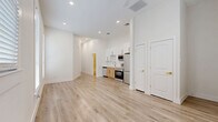 This 740 square foot, single-story apartment in San Antonio offers a thoughtfully designed living space. The open-concept layout maximizes the available area, creating a sense of spaciousness throughout. The apartment features one bedroom measuring 130 square feet, providing a cozy retreat.

The kitchen is a standout feature, boasting sleek white cabinetry with gold hardware, complemented by stainless steel appliances including a refrigerator, stove, microwave, and dishwasher. The modern aesthetic continues with a white quartz countertop and a stylish gold faucet.

Light-toned wood-look flooring runs throughout the apartment, enhancing the bright and airy atmosphere. Large windows in the living area and bedroom allow for ample natural light, while white horizontal blinds offer privacy control.

The bathroom showcases a contemporary design with marble-look tiled walls, a white bathtub, and gold accents in the fixtures. A single vanity and toilet complete the space.

The bedroom includes a closet for storage, and the apartment's efficient layout incorporates additional closet space in the common areas. The crisp white walls throughout provide a blank canvas for personalization.

This apartment combines modern amenities with a space-efficient design, perfect for those seeking a stylish urban living experience in San Antonio.