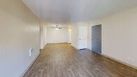 Located at 650 SW 201st Ave in Aloha, Oregon, this single-floor, two-bedroom, two-bathroom unit offers a practical and well-appointed layout. The living room serves as the central gathering space, featuring durable wood-look flooring and a sliding glass door that opens to a private balcony, allowing natural light to fill the room. The textured ceiling adds a classic residential touch throughout the common areas.

The kitchen is equipped with white shaker-style cabinetry, marble-patterned countertops, a stainless steel sink, and a dishwasher. A window above the sink provides additional natural light and outward views.

Both bedrooms are carpeted for comfort. The primary bedroom connects directly to its own bathroom, which includes a wide white vanity with marble-style countertops, a large mirror, wood-look flooring, and brushed nickel fixtures. The primary bedroom also features a walk-in closet with built-in shelving and hanging rods. The second bedroom is well-sized with a natural light source and convenient access to the second full bathroom, which mirrors the finishes of the primary bath. Warm, neutral tones are consistent throughout the unit.