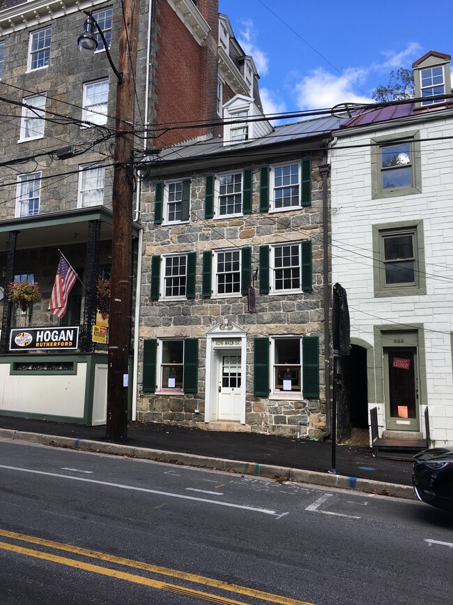 Front of building, residential apartment located through alley on second, third, & fourth floors - 8198 Main St