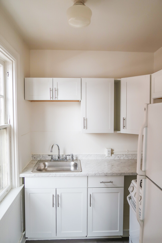 Newly renovated kitchen with gas stove and ample storage space - 325 N Duke St