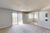 Located on Bocina Lane in Atascadero, California, this two-bedroom, one-bathroom single-floor home offers a functional and well-appointed layout. The living room serves as the central gathering space, featuring soft wall-to-wall carpeting, a textured ceiling, and a full-length sliding glass door with vertical blinds that floods the room with natural light and provides access to an outdoor patio. A ceiling fan in the adjoining dining area adds comfort and airflow throughout the open space.

The kitchen is a standout feature, showcasing gray shaker-style cabinetry, crisp white countertops, and light wood-look flooring. Stainless steel appliances — including a range, dishwasher, and refrigerator — complete the modern aesthetic, while ample upper and lower cabinet storage ensures practical functionality.

Both bedrooms are carpeted and neutral in tone, each equipped with closet space and overhead ventilation. The rooms offer a quiet, comfortable atmosphere well-suited for rest or a home office setup.

The bathroom features wood-look flooring, a gray vanity with a white countertop, a large mirror, and a shower-tub combination. A utility room and multiple closets throughout the hallway provide excellent additional storage, rounding out this efficiently designed home.
