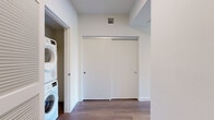 Located in the heart of Los Angeles, this modern 2-bedroom, 2-bathroom residence at 549 S Harvard Blvd offers a thoughtfully designed layout with contemporary finishes throughout. The standout feature is the curved living room, wrapped in floor-to-ceiling black-framed windows that flood the space with natural light and frame sweeping views of the Los Angeles skyline, palm trees, and surrounding cityscape. Warm wood-tone flooring runs seamlessly throughout the entire unit, complementing the clean, neutral palette.

The open kitchen is outfitted with light wood cabinetry extending to the ceiling, stainless steel appliances including a gas range, microwave, refrigerator, and dishwasher, and a white tile backsplash. A sliding glass door provides direct outdoor access from the kitchen area.

Both bedrooms are well-proportioned and bright, with large windows capturing city views. The primary bedroom benefits from generous closet space. Each of the two bathrooms features neutral large-format tile flooring, vertical mosaic tile surrounds in the tub/shower, and modern vanities with LED-lit mirrors, delivering a clean and polished aesthetic. Two dedicated closets provide ample storage throughout the residence.
