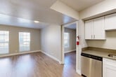 Located at 1113 W Plum St in Fort Collins, CO, this single-floor unit offers two bedrooms and two bathrooms in a practical, well-designed layout. Light wood-look flooring runs consistently throughout the space, lending a clean and cohesive aesthetic to every room. The living area is bathed in natural light from multi-pane windows and flows openly into the adjacent kitchen, which features white upper cabinetry and stainless steel appliances. The primary bedroom is a comfortable size, offering closet storage and natural light from a window with blinds. The second bedroom is similarly appointed, with wood-look flooring and a window that allows for natural light. A standout feature of the space is the dual-sink bathroom, complete with a wide vanity topped with a dark stone-style countertop, white shaker cabinetry with brushed nickel hardware, and framed mirrors — offering generous storage and counter space. The second bathroom provides additional convenience for residents or guests. Throughout the unit, neutral wall tones and clean white trim create a bright, move-in-ready atmosphere well suited to everyday living in the heart of Fort Collins.