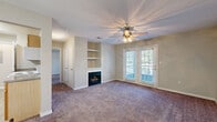 Located at 14801 Lemoyne Blvd in Biloxi, Mississippi, this single-story, one-bedroom, one-bathroom residence offers a well-organized layout across a comfortable footprint. The living room serves as the focal point of the home, featuring a fireplace flanked by built-in shelving, a ceiling fan with light fixture, and French doors fitted with blinds that open to a private patio, allowing natural light to fill the space. Soft wall-to-wall carpeting runs throughout the living, dining, and bedroom areas, contributing to a warm ambiance.

The galley-style kitchen is efficiently designed with light wood cabinetry, dark granite-style countertops, light wood-look flooring, and a full suite of white appliances including a refrigerator, electric range, microwave, and dishwasher. A utility room with electrical panel access is conveniently located just off the kitchen, alongside a dedicated laundry area.

The spacious primary bedroom features its own ceiling fan, a window with natural light, and access to four closets spread throughout the unit for ample storage. The bathroom includes a wood-tone vanity with a granite-style countertop, a large mirror, and light wood-look tile flooring. A separate dining room completes the functional layout of this Biloxi residence.