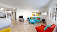 Located at The Place At 2120 in Tucson, Arizona, this 1-bedroom, 2-bathroom residence offers a well-organized single-floor layout that maximizes every square foot. The open-concept living room is bright and welcoming, featuring light wood-style flooring, a textured ceiling, and a clean white palette that serves as a canvas for bold, mid-century modern–inspired accents. The generously sized bedroom is the heart of the unit, providing ample room for rest and relaxation, with textured ceilings and wood-style flooring carried throughout. A dedicated office space offers a bright window with natural light, making it ideal for focused work or a flexible second living area. The kitchen is cleanly designed with crisp white cabinetry, light countertops, and black appliances including a range, dishwasher, and refrigerator — offering a functional and stylish cooking environment. Two full bathrooms serve the unit, each featuring a tub-shower combination, vanity, and wood-style flooring for a cohesive look. A closet provides convenient dedicated storage. The overall ambiance is lively and contemporary, with the consistent use of warm wood-tone floors and white walls creating a bright, versatile living environment throughout the home.