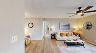Located at 1764 N Leverett Ave in Fayetteville, Arkansas, this single-floor 2-bedroom, 1-bathroom home offers a thoughtfully designed layout with a clean, modern aesthetic throughout. Light wood-look flooring flows seamlessly across the main living areas, complementing the soft neutral wall tones that create a warm and inviting ambiance.

The open living and dining area serves as the heart of the home, featuring a ceiling fan with light fixture and a set of French doors that fill the space with natural light. The adjoining kitchen is galley-style, equipped with warm wood cabinetry, white countertops, stainless steel appliances including a gas range and refrigerator, and a single-basin sink beneath a skylight that brightens the workspace.

Both bedrooms are comfortably sized, with the primary bedroom offering dual windows for ample natural light, a ceiling fan, and hardwood-style flooring. The second bedroom also features a window with an outdoor view and convenient closet access. Three closets throughout the home provide generous storage options.

The bathroom includes a full tub-shower combination with clean white subway tile surround. A central hallway connects the bedrooms and bathroom, ensuring a practical and efficient floor plan. The textured ceilings add a classic touch consistent throughout every room of this well-maintained Fayetteville home.