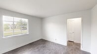 Located on Memorial Ave SW in Roanoke, Virginia, this one-bedroom, one-bathroom unit offers a thoughtfully organized single-floor layout that maximizes every square foot. Throughout the space, crisp white walls and clean white trim create a bright, fresh ambiance, complemented by durable tile-style flooring that runs consistently across the rooms.

The living room provides a comfortable gathering area, while a separate dining room offers a dedicated space for meals. The kitchen is well-equipped with white shaker-style cabinetry, a marble-look countertop, and a black electric range with overhead ventilation. A windowed door leads to the exterior, filling the kitchen with natural light and views of the surrounding neighborhood.

The bedroom is a well-proportioned retreat featuring two windows dressed with blinds that invite natural light while maintaining privacy. The room connects conveniently to a hallway with access to two closets, providing ample storage.

The bathroom showcases classic white subway tile walls surrounding a full soaking tub, accented by charming vintage-style mosaic tile flooring in warm yellow and brown tones. A window with blinds adds ventilation and natural light.

The entire unit presents a clean, move-in-ready condition with a neutral aesthetic well-suited to a variety of personal styles.