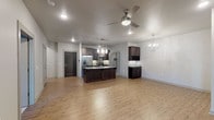 Located at 3405 S Bowman Rd in Little Rock, Arkansas, this single-floor residence offers a thoughtfully designed open-concept layout with modern finishes throughout. The kitchen serves as the centerpiece of the main living area, showcasing dark espresso cabinetry, granite countertops, a large center island with pendant lighting, a tile backsplash, and stainless steel appliances. Light wood-style flooring extends across the open living and kitchen space, complemented by a ceiling fan and an elegant globe chandelier that adds a contemporary touch. A built-in wine rack and additional cabinetry provide ample storage.

The bedrooms feature plush carpeting, ceiling fans, and built-in media niches. One bedroom includes a spacious walk-in closet with rod and shelf storage. Natural light enters through window treatments, creating a comfortable atmosphere.

The bathrooms are finished with large-format tile flooring and matching wall tile. One bathroom features a granite-topped dark vanity and a glass-enclosed tub-shower combination, while another offers a granite double-vanity and a walk-in glass shower with a rainfall showerhead, delivering a spa-like experience. The overall design emphasizes clean lines, neutral tones, and quality materials throughout.
