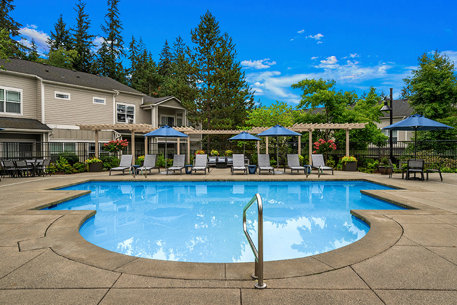 Large pool deck with lounge chairs - The Lodge at Redmond Ridge