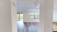 This 800 square foot, single-floor apartment offers a harmonious blend of comfort and style. The open-concept design seamlessly integrates the living room and kitchen, creating a spacious feel. The living area is adorned with stylish wood-look flooring and benefits from ample natural light through large windows and a sliding glass door leading to a private balcony.

The kitchen is a highlight, featuring sleek white cabinetry, granite countertops, and stainless steel appliances, including a modern range and over-the-range microwave. A breakfast bar provides additional seating and separates the kitchen from the living space.

The bedroom, measuring 150 square feet, is generously sized and includes a ceiling fan for comfort. Two closets offer abundant storage space. The bathroom boasts a contemporary design with a granite vanity top, large mirror, and a shower/tub combination.

Throughout the apartment, recessed lighting and ceiling fans enhance the ambiance. The neutral color palette and modern fixtures create a fresh, inviting atmosphere. This well-designed space maximizes functionality and style, perfect for comfortable, contemporary living.