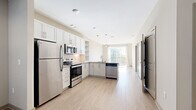 Located at 7600 Cabot Dr in Nashville, TN, this single-story, 1-bedroom, 2-bathroom residence offers a thoughtfully designed open-concept layout. Light wood-style flooring flows throughout the main living areas, complementing the neutral color palette and creating a bright, cohesive feel.

The kitchen is a standout feature, outfitted with white shaker-style cabinetry, granite countertops, a classic subway tile backsplash, and a full suite of stainless steel appliances including a refrigerator, range, microwave, and dishwasher. Pendant lighting accents the space, which opens directly toward the living area and a sliding glass door leading to a private balcony.

The living room is generously proportioned with large windows that allow abundant natural light to fill the space. Light hardwood-style flooring continues here, enhancing the airy ambiance. The bedroom features plush carpeting, a ceiling fan, a dedicated window with blinds, and a closet, offering a comfortable and private retreat.

The full bathroom is well-appointed with a granite-topped double vanity, white shaker cabinetry, a tiled soaking tub and shower combination, and built-in shelving for added storage. The overall design is clean, modern, and move-in ready.