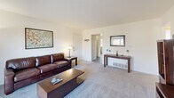 Located at 1307 W Lincoln Hwy in DeKalb, Illinois, this 2-bedroom, 2-bathroom unit offers a practical and comfortable single-floor layout. The living room is carpeted and bathed in natural light, featuring a sliding glass door that opens to a private balcony with outdoor views — an inviting space for relaxing or entertaining. The kitchen is well-equipped with warm wood cabinetry, white appliances including a gas range, dishwasher, and refrigerator, complemented by a tile floor and a dedicated dining area with direct access to an exterior door. The primary bedroom is a comfortable retreat with carpet flooring, a bright window, and a built-in closet. The second bedroom, also carpeted with a window, offers flexible use as a guest room or home office. Both bathrooms include tub-shower combinations with tiled surrounds. A hallway connects the rooms efficiently, contributing to a cohesive and functional floor plan. With its proximity to Northern Illinois University, this unit is ideally suited for students, faculty, or anyone seeking convenient DeKalb living.