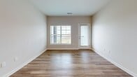 Located at 2550 Pillow Dr in Columbia, Tennessee, this well-appointed 2-bedroom, 2-bathroom home offers a thoughtfully designed single-floor layout with a clean, modern aesthetic throughout. The open-concept kitchen and living area serves as the heart of the home, featuring white shaker cabinetry, dark countertops, stainless steel appliances, a center island with pendant lighting, and recessed ceiling lights — all set atop warm hardwood-style flooring that extends through the main living spaces. The living room receives natural light through large windows and includes a private exterior door. Both bedrooms are generously sized, with the spacious primary bedroom offering plush carpeting, a ceiling fan, and ample natural light from a window with outdoor views. The two bathrooms are finished with white shaker vanities, dark countertops, large mirrors, and tub/shower combinations. Three closets provide excellent storage throughout the home. A dedicated laundry room with washer and dryer hookups — complete with built-in shelving — adds everyday convenience. The home's neutral palette, quality finishes, and functional layout make it a comfortable and practical living space in Columbia, TN.