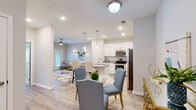 Located at 185 Rosewood Loop in Burlington, NC, this one-bedroom, one-bathroom residence offers a thoughtfully designed open-concept layout finished with light wood-style flooring and a neutral color palette throughout. The kitchen is a standout feature, showcasing crisp white shaker cabinetry, granite countertops, stainless steel appliances, and a peninsula with bar seating — all illuminated by stylish pendant lighting and recessed fixtures. It flows seamlessly into the dining area and the bright, welcoming living room, where French doors open to a private balcony, filling the space with natural light. A ceiling fan adds comfort to the living area. The bedroom offers carpeted flooring, a ceiling fan, and a window with natural light, providing a calm and restful retreat. A dedicated closet provides convenient storage. The bathroom features a full tub-shower combination with clean tile surround and wood-style flooring. Additional functional space includes a versatile nook area with wood-style flooring, ideal for a sitting area or workspace. The overall ambiance is bright, clean, and modern — a comfortable home designed for everyday living.
