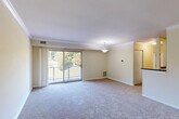 Located at 1105 Nalley Rd in Hyattsville, Maryland, this 2-bedroom, 1-bathroom residence offers a practical and comfortable single-floor layout. The open combined living and dining area serves as the heart of the home, featuring soft carpeting, crown molding, and a pendant light fixture. Large sliding glass doors lead to a private balcony overlooking lush greenery, filling the space with natural light and scenic outdoor views. The kitchen is well-appointed with warm wood cabinetry, dark granite-style countertops, tile flooring, stainless steel refrigerator, a gas range, and over-the-range microwave — offering efficient functionality in a compact footprint. Both bedrooms are carpeted and finished in neutral tones. The primary bedroom features a ceiling fan with light fixture and a window with natural light, while the second bedroom includes a sliding closet and connects easily to the hallway. The unit also provides three closets for ample storage and an in-unit laundry area for added convenience. A connecting hallway ties all rooms together in a cohesive, easy-to-navigate layout. The overall ambiance is calm, clean, and move-in ready, making it a practical choice in the Hyattsville area.