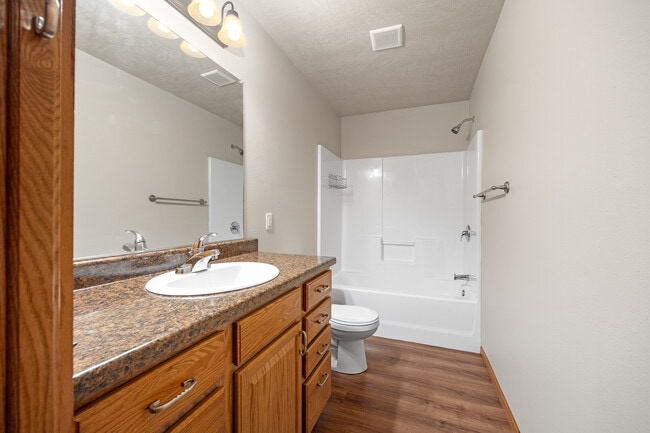 Bath off hall, with linen cabinet - Fifth Street Apartments & Townhouses