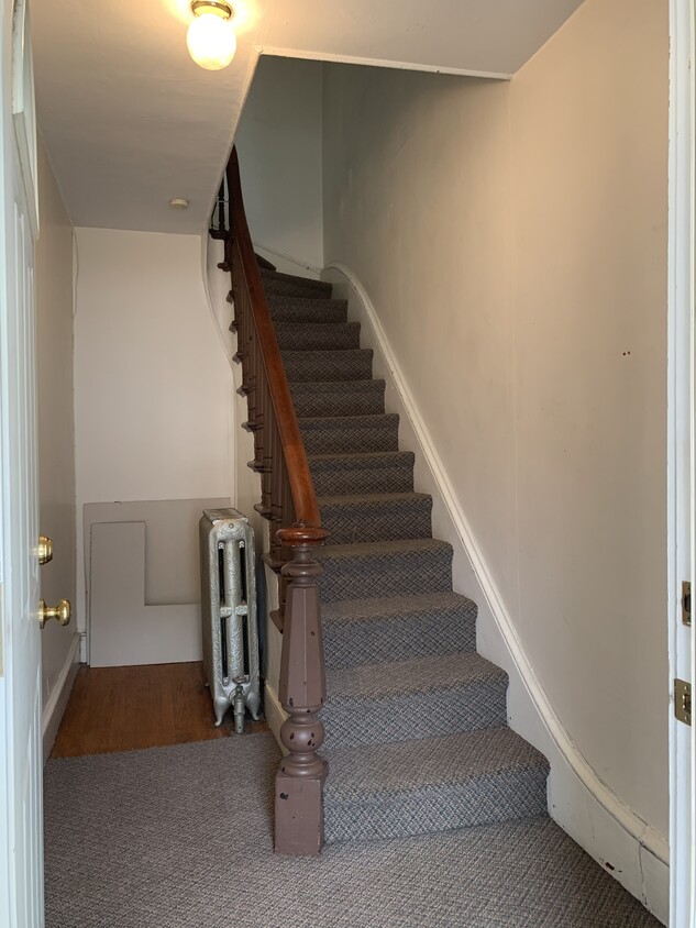 Private staircase to apartment with storage - 2716 W Main St
