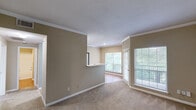 Located at 9104 McQueen Dr in Durham, NC, this single-floor, 2-bedroom, 3-bathroom home offers a practical and comfortable layout. The kitchen is galley-style with wood-look flooring, white cabinetry, light countertops, a stainless steel microwave, electric range, refrigerator, and dishwasher. Natural light filters in through windows overlooking greenery, creating a bright cooking and dining space. The primary bedroom is a generously sized retreat with soft carpeting, a ceiling fan, and direct access to both a walk-in closet fitted with wire shelving and an en-suite bathroom. The second bedroom also features carpet flooring and a ceiling fan, offering a comfortable and airy feel. All three bathrooms are clean and functional, with at least one featuring a tub-shower combo, single vanity, and wood-look flooring. The two closets provide well-organized wire rack storage. A dedicated laundry room houses an in-unit washer and includes shelving for added utility. Throughout the home, neutral warm-toned walls, panel-style doors with brass hardware, and consistent flooring choices lend a cohesive and understated aesthetic. The hallway connects all rooms efficiently, completing this well-organized and move-in-ready home.