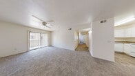 Located at 4415 S 28th St in Phoenix, AZ, this single-floor home offers four bedrooms and two full bathrooms within a well-organized and functional layout. The living room serves as the heart of the home, featuring plush carpeting, a ceiling fan, and a sliding glass door that fills the space with natural light and provides access to an outdoor patio. A dedicated entry area with wood-look flooring transitions smoothly into the carpeted living space.

The kitchen is equipped with white cabinetry, laminate countertops, a white electric range, a dishwasher, and a double sink — all set atop wood-look flooring that adds warmth to the space. The layout is efficient and practical for everyday use.

Each of the four bedrooms is carpeted and features vertical blind-covered windows that allow natural light while maintaining privacy. The primary bedroom includes a spacious closet with built-in shelving and hanging rods. The additional bedrooms are well-proportioned and versatile. A hallway connects all rooms, providing a clear and accessible flow throughout the home.

Both bathrooms include full tub/shower combinations with chrome fixtures and white surrounds. One bathroom features wood-look tile flooring, adding a modern touch. The overall aesthetic of the home is clean, neutral, and move-in ready.