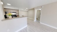 Located at 4760 W Atlantic Blvd in Coconut Creek, FL, this well-appointed one-bedroom, one-bathroom residence offers a clean, modern aesthetic throughout. Light-toned tile flooring runs seamlessly across the entire living space, reflecting natural light and enhancing the open, airy feel.

The open-concept living and dining area is spacious and bright, with neutral walls and large sliding glass doors that lead to a private patio overlooking a landscaped outdoor courtyard area. The kitchen features light wood cabinetry, granite-style countertops, a peninsula breakfast bar, black appliances including a range and refrigerator, and a dedicated pantry closet — all designed for both functionality and style.

The bedroom is comfortably sized, offering a large window with views of the surrounding greenery, allowing for generous natural light. Two closets provide ample storage throughout the unit. The bathroom is well-equipped with a full tub/shower combo, a wide vanity with granite-style countertops, wood-toned cabinetry, and a large wall mirror with bright overhead lighting. In-unit laundry adds everyday convenience. The overall ambiance is clean, contemporary, and move-in ready.