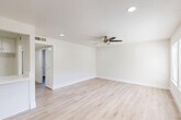 Located at 3505 W Campus Ave in Visalia, CA, this thoughtfully designed 2-bedroom, 1-bathroom single-story home offers a clean, modern aesthetic from top to bottom. Light wood-style flooring flows consistently throughout the entire space, creating a cohesive and welcoming atmosphere.

The open living and dining area serves as the heart of the home, featuring recessed lighting, a stylish ceiling fan, and a neutral white palette that enhances the sense of openness. A peninsula-style kitchen with white shaker cabinetry, white quartz countertops, a stainless steel gas range with a sleek overhead range hood, a dishwasher, and a double-basin sink with brushed gold fixtures offers both function and style. The kitchen opens directly to the living area, making it ideal for everyday living.

Both bedrooms are well-proportioned and finished with the same light flooring. The primary bedroom includes a sliding double-door closet and benefits from natural light. The second bedroom features a window with outdoor views. The space also includes four closets total, offering ample storage throughout.

The full bathroom is finished in a crisp white palette with white cabinetry, quartz countertops, brushed gold hardware, and a full tub-shower combination. A hallway connects the private areas of the home, completing this efficient and move-in-ready layout.
