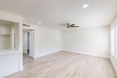 Located at 3505 W Campus Ave in Visalia, CA, this thoughtfully designed 2-bedroom, 1-bathroom single-story home offers a clean, modern aesthetic from top to bottom. Light wood-style flooring flows consistently throughout the entire space, creating a cohesive and welcoming atmosphere.

The open living and dining area serves as the heart of the home, featuring recessed lighting, a stylish ceiling fan, and a neutral white palette that enhances the sense of openness. A peninsula-style kitchen with white shaker cabinetry, white quartz countertops, a stainless steel gas range with a sleek overhead range hood, a dishwasher, and a double-basin sink with brushed gold fixtures offers both function and style. The kitchen opens directly to the living area, making it ideal for everyday living.

Both bedrooms are well-proportioned and finished with the same light flooring. The primary bedroom includes a sliding double-door closet and benefits from natural light. The second bedroom features a window with outdoor views. The space also includes four closets total, offering ample storage throughout.

The full bathroom is finished in a crisp white palette with white cabinetry, quartz countertops, brushed gold hardware, and a full tub-shower combination. A hallway connects the private areas of the home, completing this efficient and move-in-ready layout.