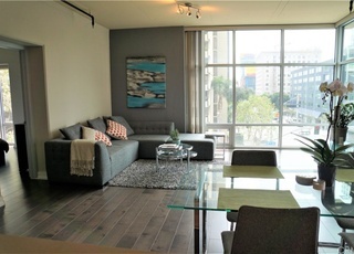 Living area with floor to ceiling windows - 645 W 9th St